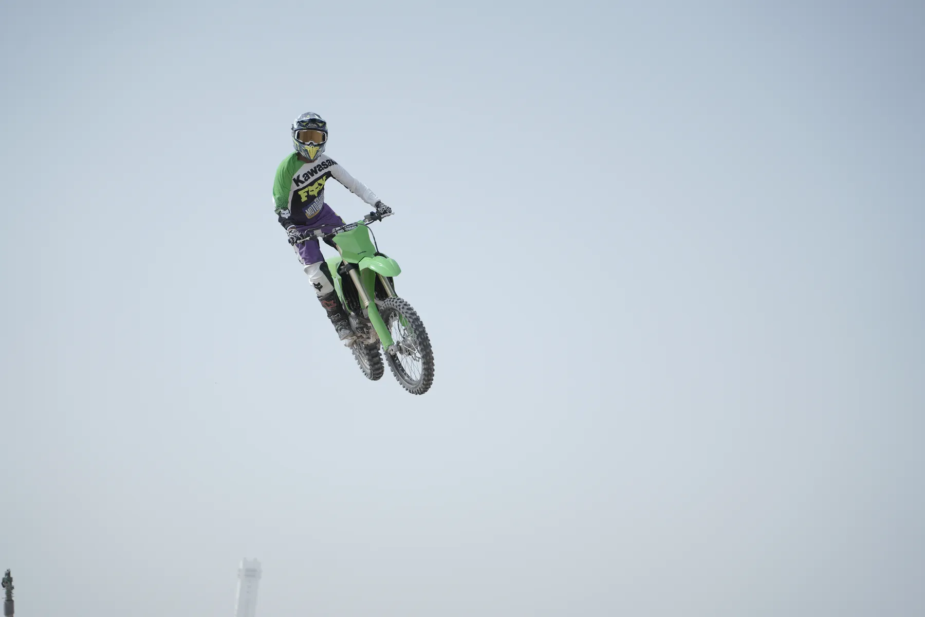 Motocross rider in mid-air against the sky