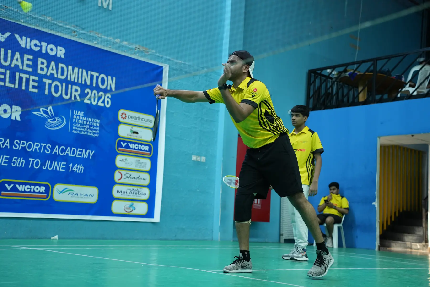 Badminton player smashing at the UAE Badminton Elite Tour 2026